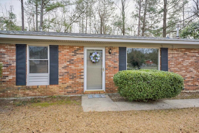 doorway to property featuring a lawn