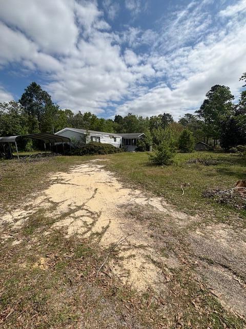2433 Patiller Rd, Hephzibah, GA 30815 - view of front facade with dirt driveway and a detached carport