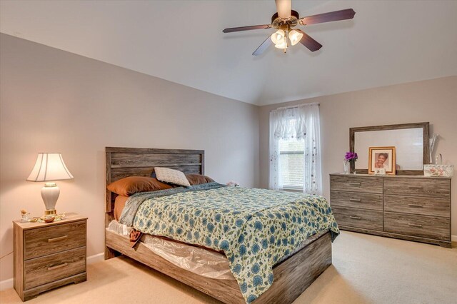 carpeted bedroom featuring ceiling fan and vaulted ceiling