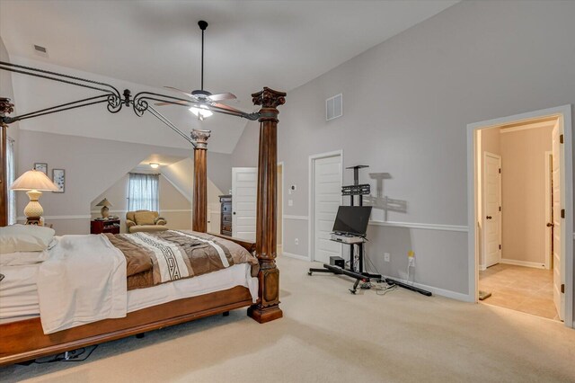 carpeted bedroom featuring ceiling fan and vaulted ceiling