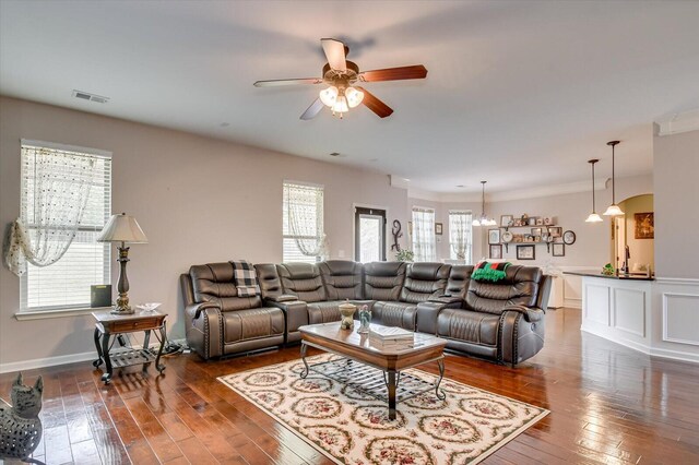 living room with dark hardwood / wood-style floors, a healthy amount of sunlight, and ceiling fan