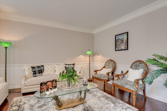 living room with dark hardwood / wood-style floors and ornamental molding