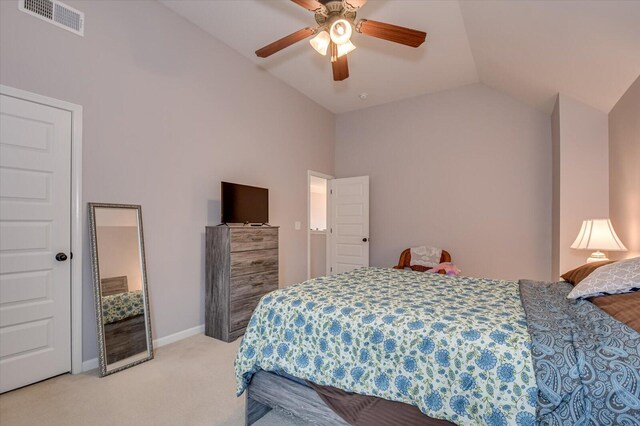 bedroom with ceiling fan, light carpet, and vaulted ceiling