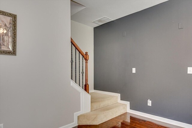 stairway featuring wood-type flooring