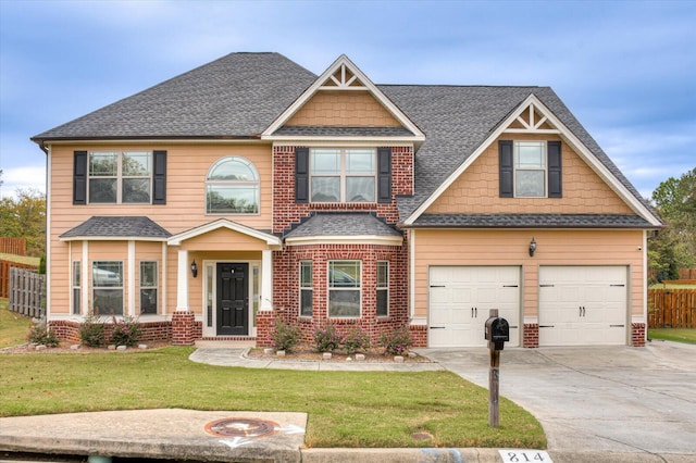 craftsman-style house featuring a garage and a front yard