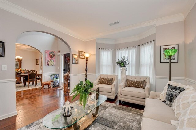 living room with dark hardwood / wood-style floors and ornamental molding