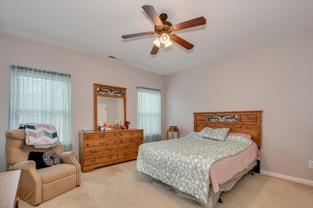 carpeted bedroom with ceiling fan