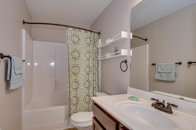 full bathroom featuring vanity, shower / bathtub combination with curtain, and toilet