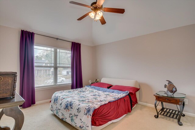 carpeted bedroom featuring multiple windows, ceiling fan, and lofted ceiling