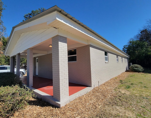 view of property exterior with brick siding