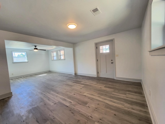 entrance foyer with baseboards, visible vents, and wood finished floors