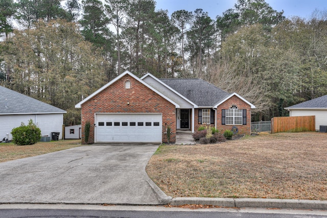 view of front of property with cooling unit, a front yard, and a garage