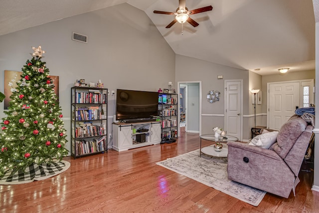 living room featuring hardwood / wood-style flooring, ceiling fan, and lofted ceiling