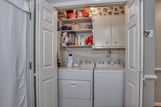 laundry area featuring cabinets and separate washer and dryer