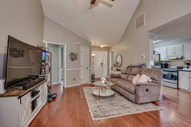 living room featuring high vaulted ceiling, light hardwood / wood-style flooring, and ceiling fan