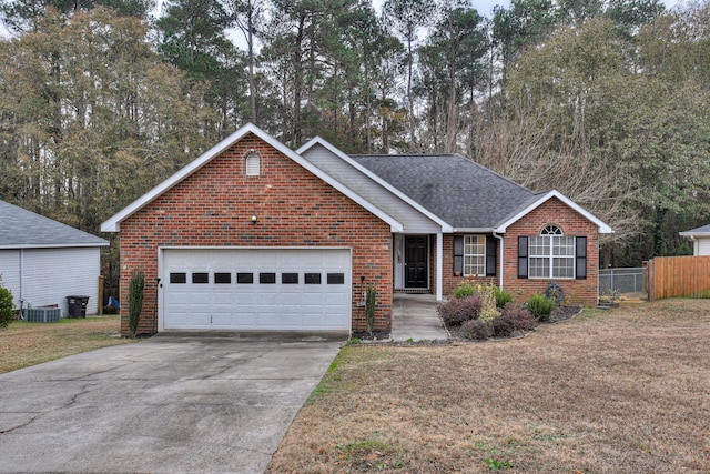 single story home featuring a front lawn, cooling unit, and a garage