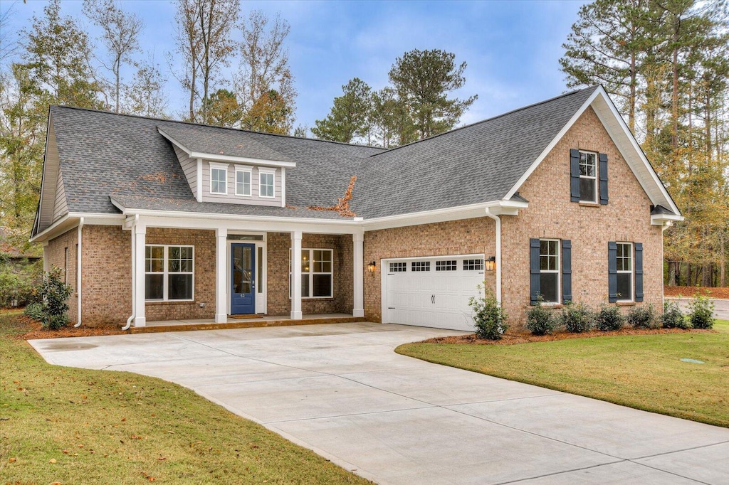 view of front of property featuring a garage and a front yard