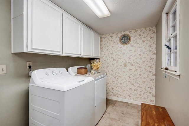 washroom with separate washer and dryer, cabinets, and a textured ceiling