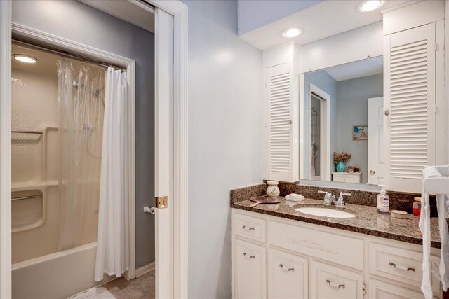 bathroom with tile patterned floors, vanity, and shower / tub combo