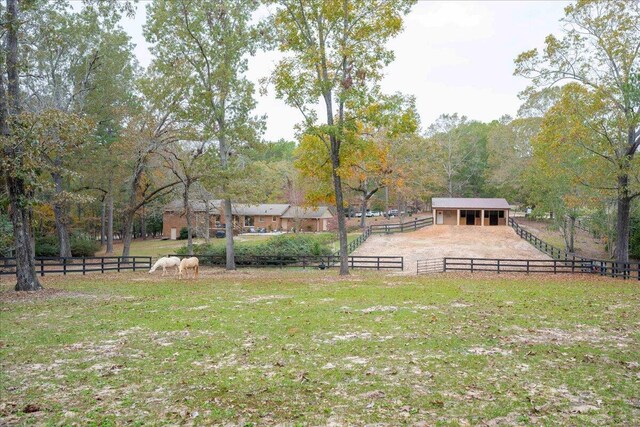 view of yard with a rural view and an outdoor structure