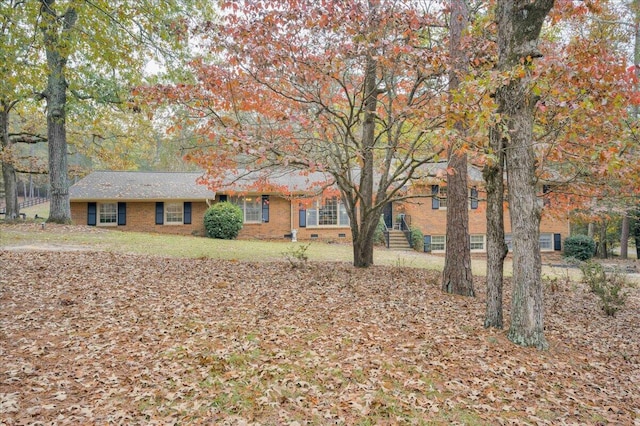 ranch-style home with a front lawn