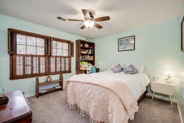 bedroom featuring ceiling fan and light carpet