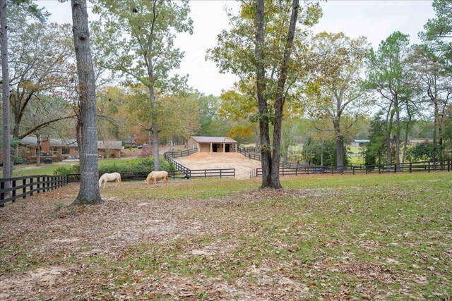 view of yard featuring a rural view and an outbuilding