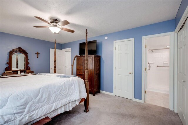 carpeted bedroom with a textured ceiling, ceiling fan, and connected bathroom