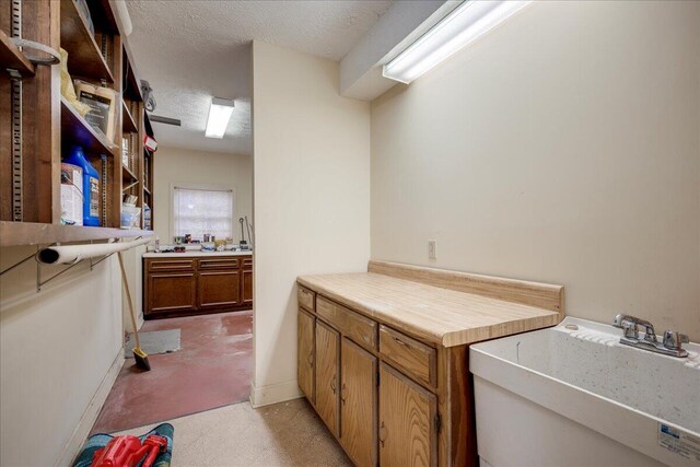 interior space with sink and a textured ceiling