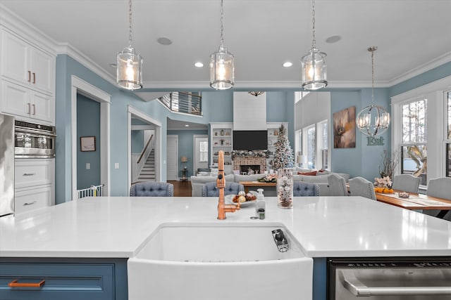 5416 Old Washington Rd, Evans, GA 30809 - kitchen with dishwasher, ornamental molding, open floor plan, a fireplace, and light countertops