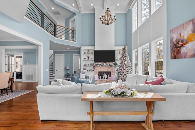 5416 Old Washington Rd, Evans, GA 30809 - living area with a high ceiling, crown molding, stairs, a chandelier, and a fireplace