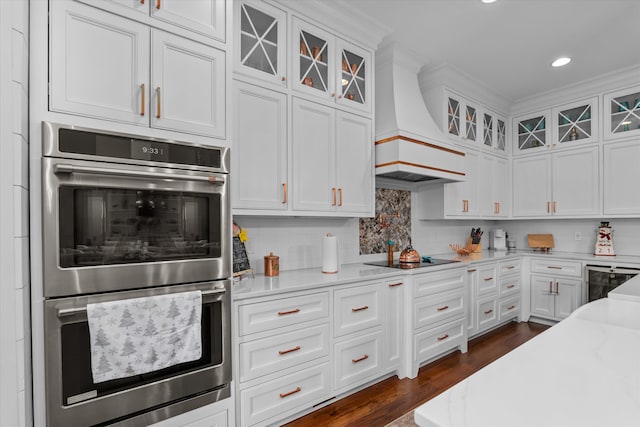 5416 Old Washington Rd, Evans, GA 30809 - kitchen with double oven, custom exhaust hood, black electric stovetop, white cabinetry, and decorative backsplash