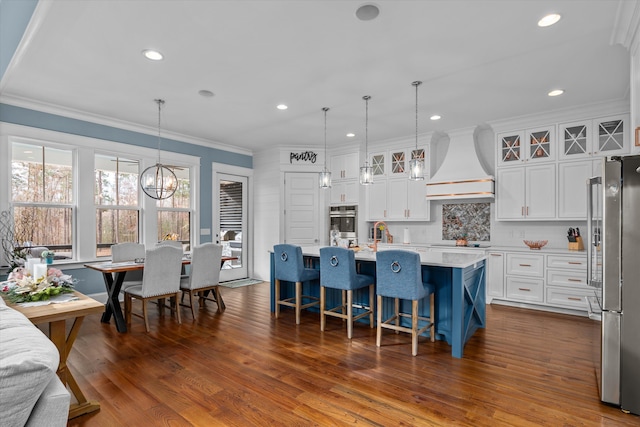 5416 Old Washington Rd, Evans, GA 30809 - kitchen featuring custom exhaust hood, freestanding refrigerator, light countertops, ornamental molding, and recessed lighting