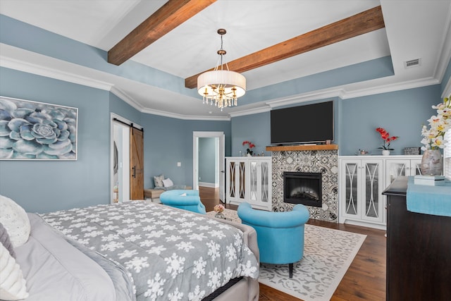5416 Old Washington Rd, Evans, GA 30809 - bedroom featuring wood finished floors, a barn door, a chandelier, beam ceiling, and a tile fireplace