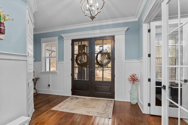 5416 Old Washington Rd, Evans, GA 30809 - foyer entrance with french doors, a decorative wall, a chandelier, wainscoting, and crown molding