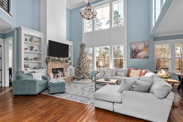 5416 Old Washington Rd, Evans, GA 30809 - living room with a towering ceiling, plenty of natural light, a chandelier, ornamental molding, and wood finished floors