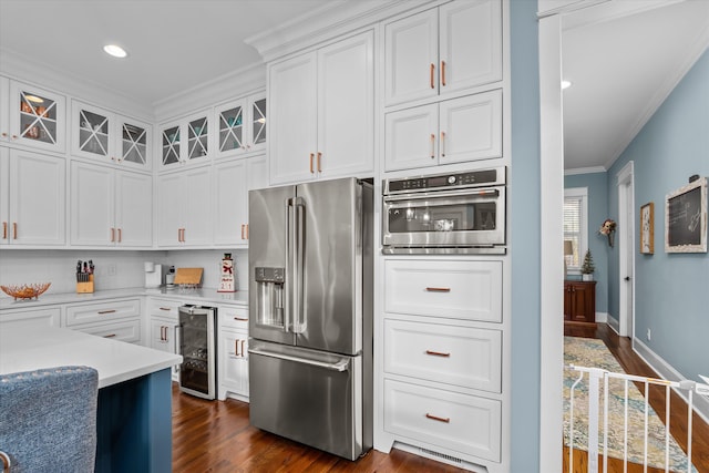 5416 Old Washington Rd, Evans, GA 30809 - kitchen with stainless steel appliances, wine cooler, ornamental molding, dark wood finished floors, and glass insert cabinets