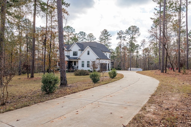5416 Old Washington Rd, Evans, GA 30809 - view of front facade featuring curved driveway, an attached garage, and board and batten siding