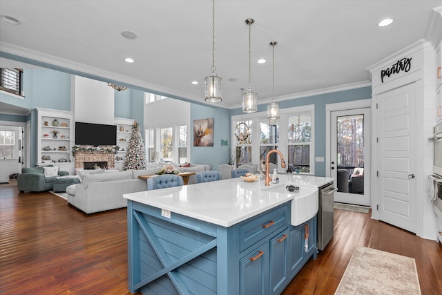 5416 Old Washington Rd, Evans, GA 30809 - kitchen with blue cabinets, ornamental molding, stainless steel dishwasher, dark wood-style floors, and recessed lighting