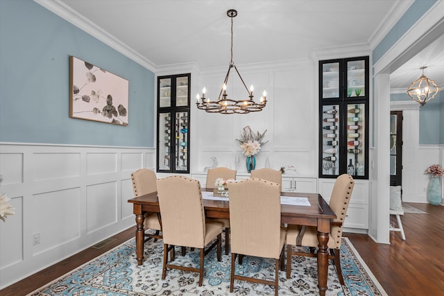 5416 Old Washington Rd, Evans, GA 30809 - dining space featuring a decorative wall, a chandelier, crown molding, dark wood-type flooring, and wainscoting