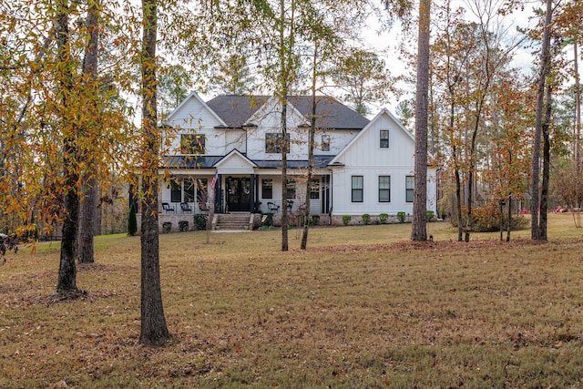 5416 Old Washington Rd, Evans, GA 30809 - modern farmhouse style home with board and batten siding, a porch, a balcony, and a front lawn