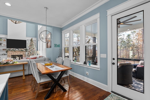 5416 Old Washington Rd, Evans, GA 30809 - dining space with a chandelier, ornamental molding, dark wood finished floors, a ceiling fan, and a fireplace