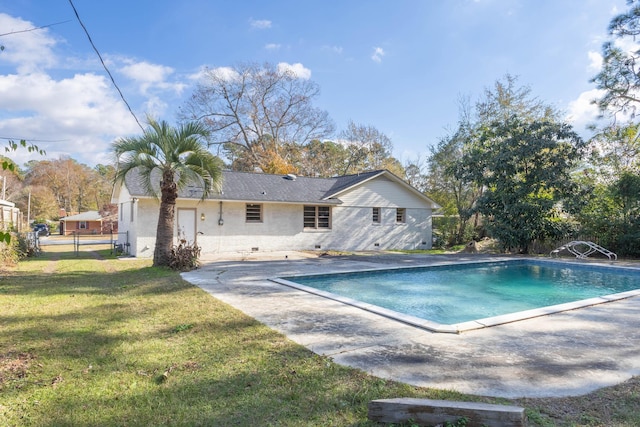 view of swimming pool featuring a lawn and a patio area