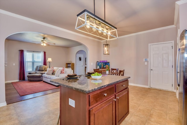 324 Congling Cir, Grovetown, GA 30813 - kitchen featuring arched walkways, ornamental molding, baseboards, a kitchen island, and dark stone counters