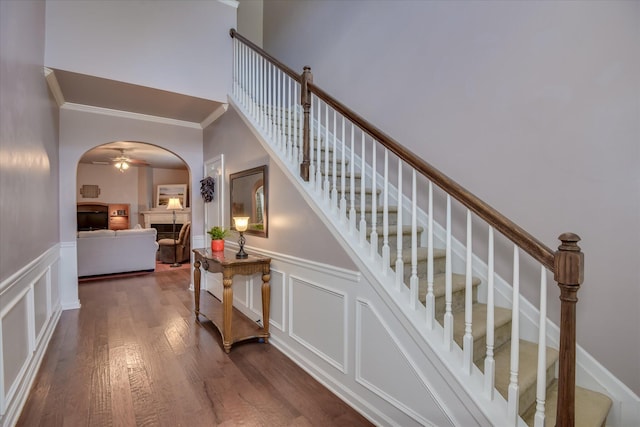 324 Congling Cir, Grovetown, GA 30813 - stairway with arched walkways, a decorative wall, ornamental molding, wood finished floors, and wainscoting