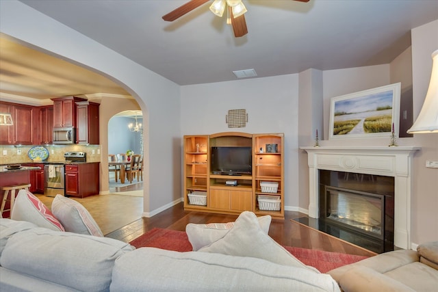 324 Congling Cir, Grovetown, GA 30813 - living area featuring arched walkways, wood finished floors, ceiling fan, baseboards, and a glass covered fireplace