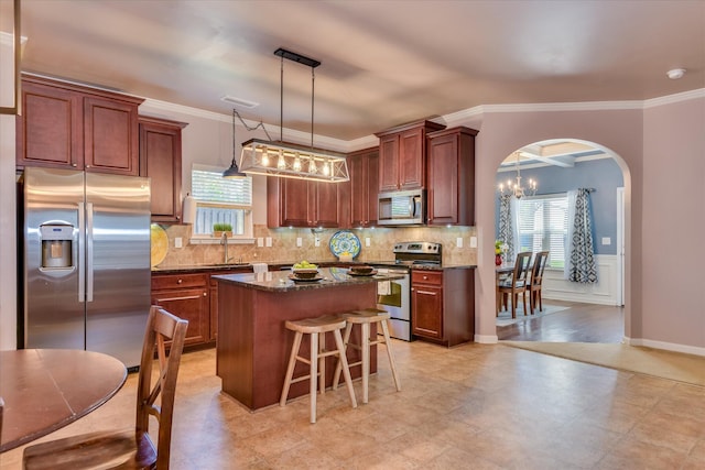 324 Congling Cir, Grovetown, GA 30813 - kitchen featuring appliances with stainless steel finishes, arched walkways, a center island, a breakfast bar area, and a sink