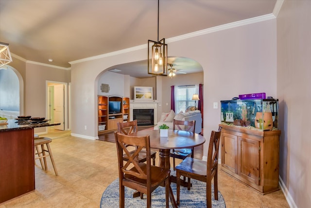 324 Congling Cir, Grovetown, GA 30813 - dining area featuring arched walkways, a glass covered fireplace, ornamental molding, ceiling fan, and baseboards