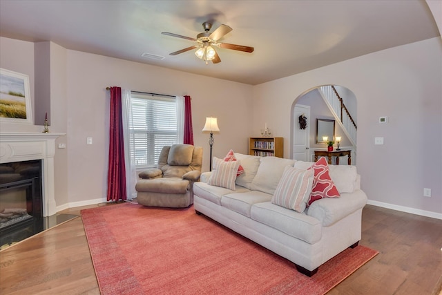 324 Congling Cir, Grovetown, GA 30813 - living area featuring arched walkways, wood finished floors, a ceiling fan, baseboards, and a glass covered fireplace