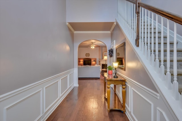 324 Congling Cir, Grovetown, GA 30813 - corridor featuring ornamental molding, a decorative wall, wainscoting, dark wood-style floors, and arched walkways